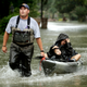 People evacuate a neighborhood inundated by floodwaters from Tropical Storm Harvey on Aug. 28, in Houston.